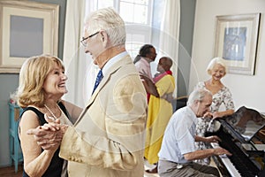 Group Of Seniors Enjoying Dancing Club Together