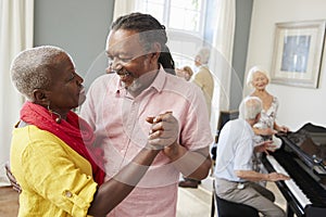 Group Of Seniors Enjoying Dancing Club Together