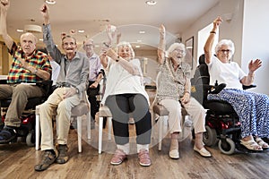 Group Of Seniors Enjoying Fitness Class In Retirement Home