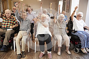 Group Of Seniors Enjoying Fitness Class In Retirement Home