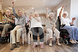 Group Of Seniors Enjoying Fitness Class In Retirement Home photo