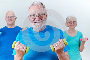 Group Of Seniors In Fitness Class Using Weights