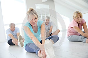Group of seniors making stretching excercises photo
