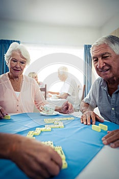 Group of seniors playing dominoes