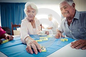 Group of seniors playing dominoes