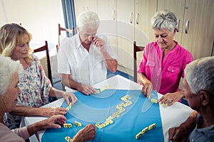 Group of seniors playing dominoes