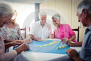 Group of seniors playing dominoes