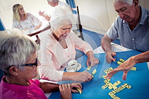 Group of seniors playing dominoes