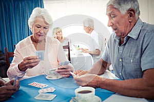 Group of seniors playing dominoes