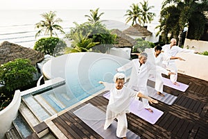 Group of seniors practicing yoga in the morning