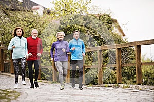 Group of seniors running outdoors in the old town.