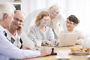 Group of seniors sitting at table