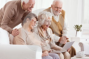 Group of seniors using laptop