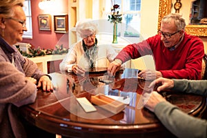 Group of senor people playing board games