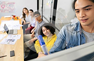 Group of serious young Asian creative business people team meeting in modern office