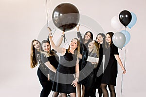 Group of seven girls best friends making selfie on smartphone, enjoying birthday party with cake and air balloons