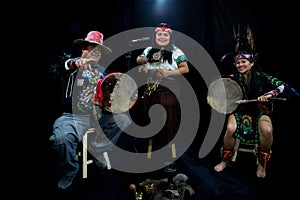 group of shaman Teotihuacanos, Xicalanca - Toltec in black background, with traditional dress dance with a trappings with feathers