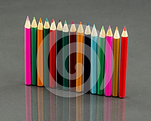 Group of sharp colored pencils with reflexions