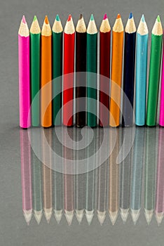 Group of sharp colored pencils with reflexions