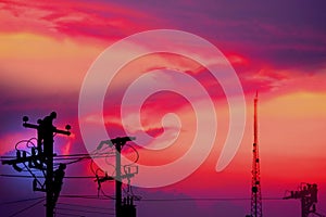 group of silhouette electric worker working on pole connected high voltage transmission line with high volttag transmission