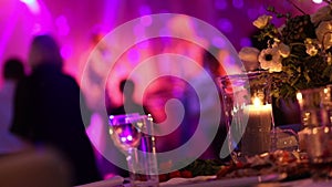 Group of silhouetted people dancing in a dark banquet hall for a wedding reception.The Wedding Banquet, people dance -