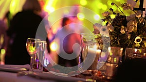 Group of silhouetted people dancing in a dark banquet hall for a wedding reception.The Wedding Banquet, people dance -