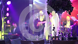 Group of silhouetted people dancing in a dark banquet hall for a wedding reception.The Wedding Banquet, people dance -