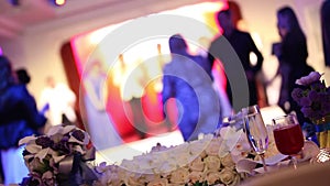 Group of silhouetted people dancing in a dark banquet hall for a wedding reception.The Wedding Banquet, people dance -