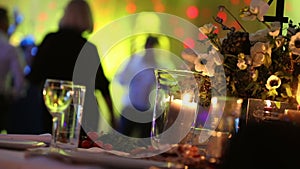 Group of silhouetted people dancing in a dark banquet hall for a wedding reception.The Wedding Banquet, people dance -