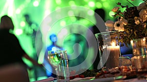 Group of silhouetted people dancing in a dark banquet hall for a wedding reception.The Wedding Banquet, people dance -