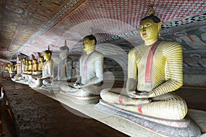 Group of sitting Buddha statues in cave buddhist temple