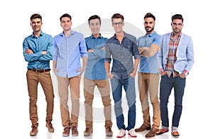 Group of six young casual men standing confidently