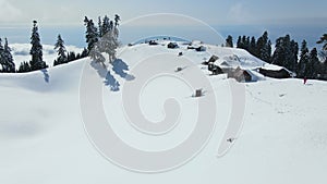 A group of ski touring enthusiasts on top of a snow-covered mountain