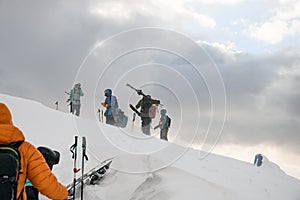 group of ski tourists with backpacks on winter snowy Carpathian mountains. Ski touring concept