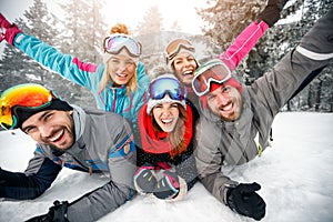 Group of skiers enjoying together on snow in mountain