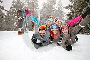 Group of skiers lying on snow and having fun