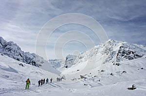 Group of skiers touring uphill