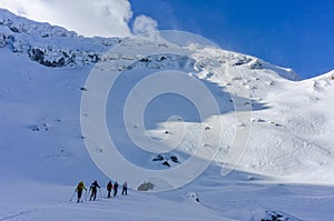 Group of skiers touring uphill