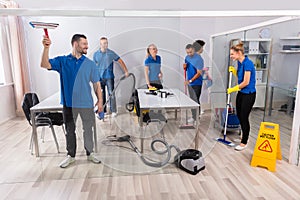 Group Of Skilled Janitors Cleaning Office