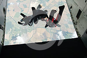 Group of skydivers exit an airplane