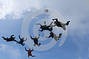 A group of skydivers. Skydiving is in the sky.