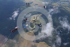 A group of skydivers. Skydiving is in the sky.