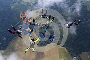 A group of skydivers. Skydiving is in the sky.