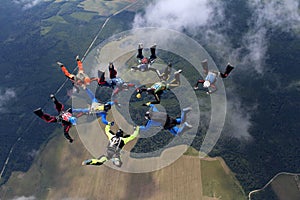 A group of skydivers. Skydiving is in the sky.