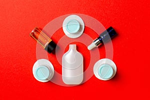 Group of small bottles for travelling on colored background. Copy space for your ideas. Flat lay composition of cosmetic