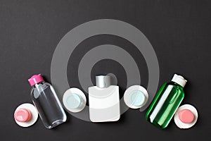 Group of small bottles for travelling on colored background. Copy space for your ideas. Flat lay composition of cosmetic products
