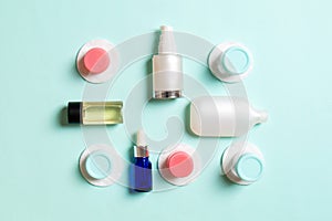 Group of small bottles for travelling on colored background. Copy space for your ideas. Flat lay composition of cosmetic products