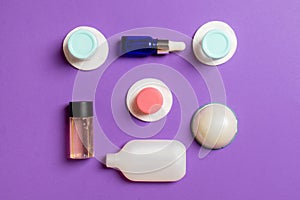 Group of small bottles for travelling on colored background. Copy space for your ideas. Flat lay composition of cosmetic products