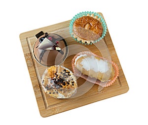 Group of small cakes of different flavors and sizes on isolated background