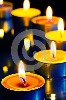 A group of small candles on dark background